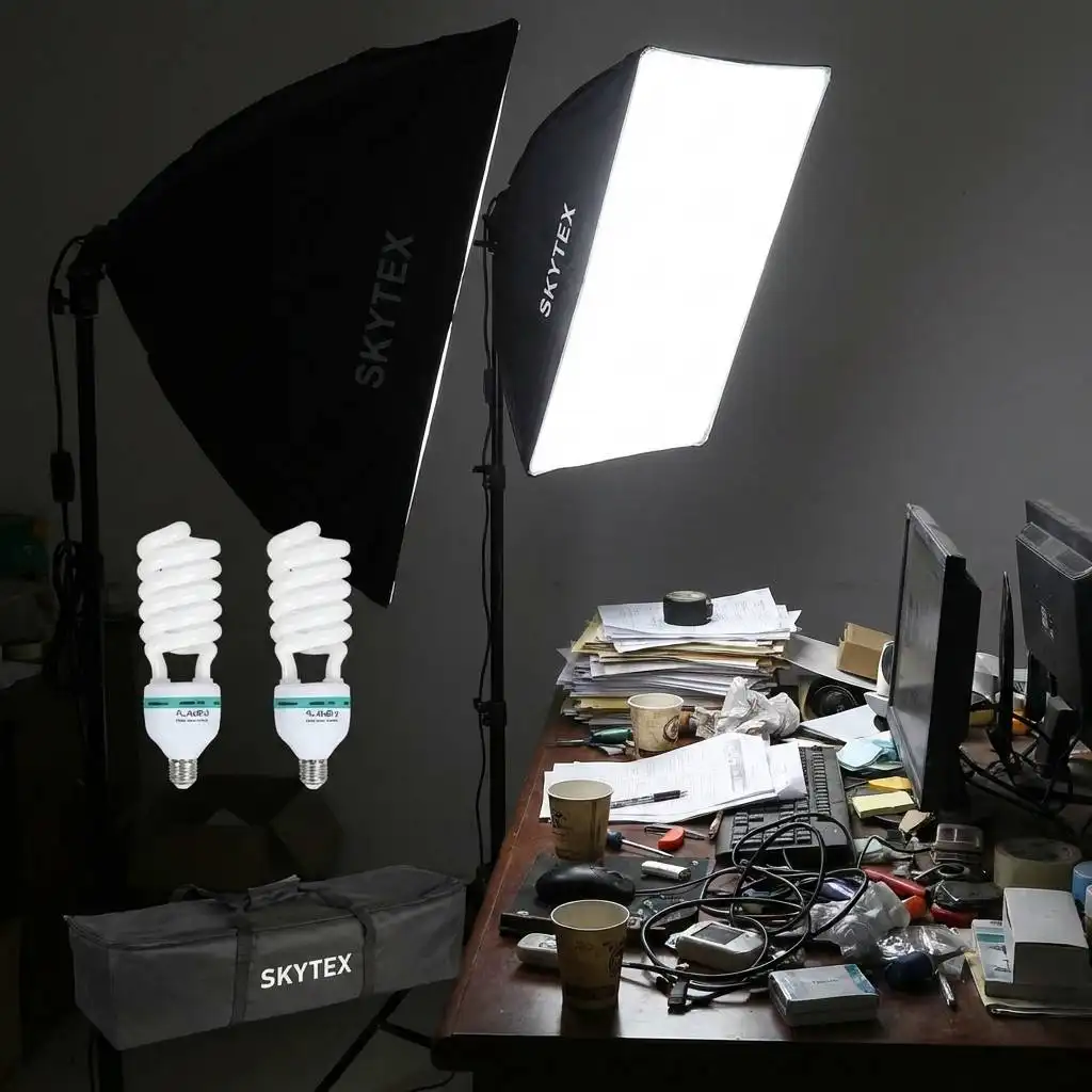 Harsh softbox light illuminating a cluttered desk in a dimly lit room to test brightness. Harsh softbox light illuminating a cluttered desk in a dimly lit room to test brightness.